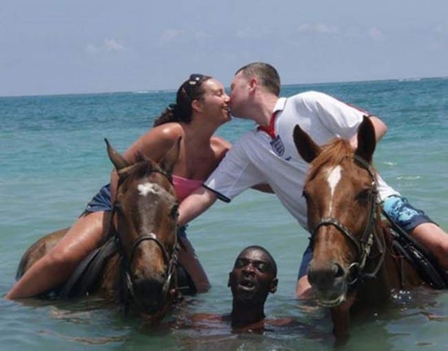 Holiday Snaps Kissing While Riding Horses In Water